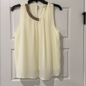 Soft cream colored sleeveless blouse